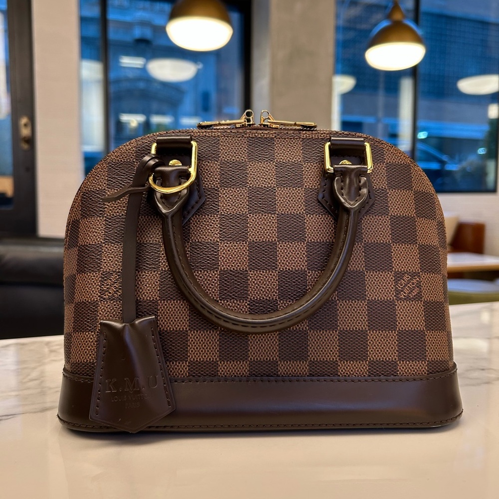 Louis Vuitton Alma BB in Damier Ebene.